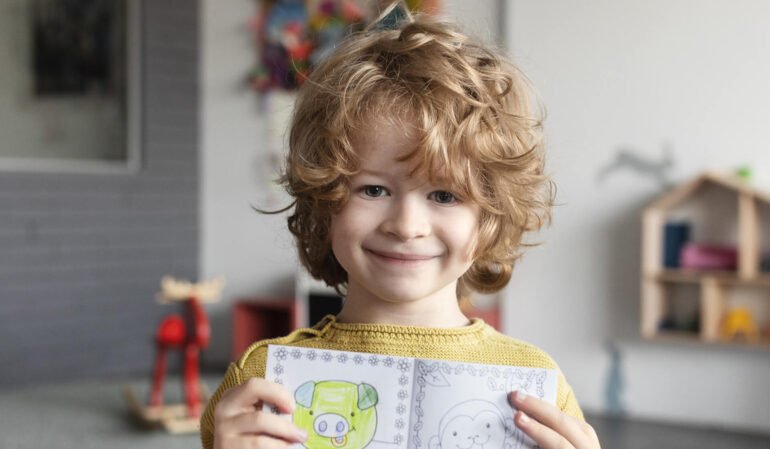 Child Holding Colouring Book